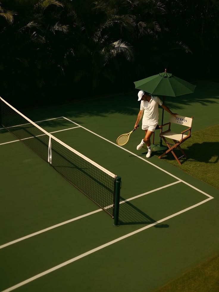 A player beside a green umbrella and a Tennis Club chair